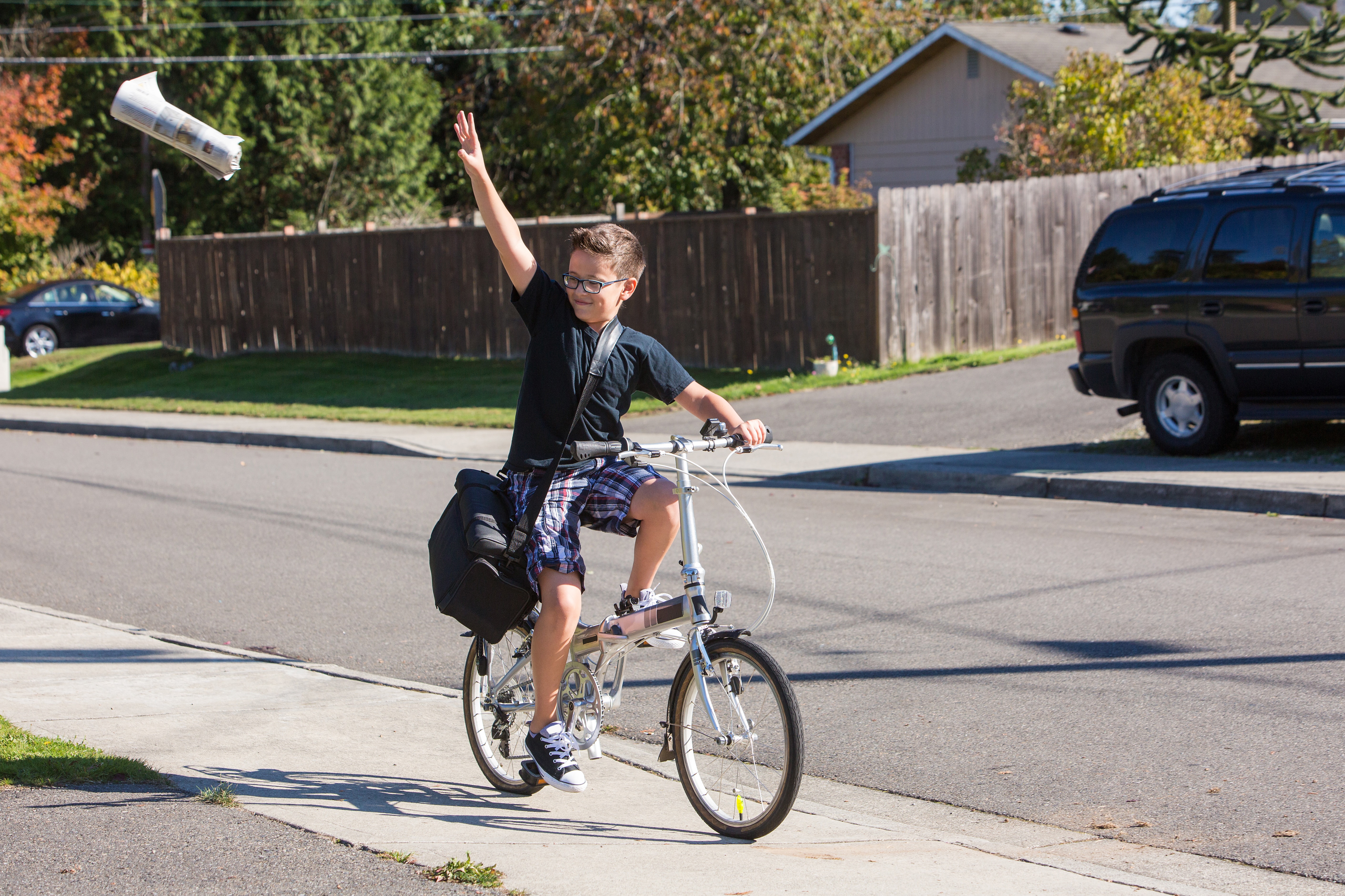 Paper delivery boy. Paperboy move. Children deliver newspaper by Bike. Delivery boy.